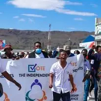 The Independents supporters marching with a campaign banner